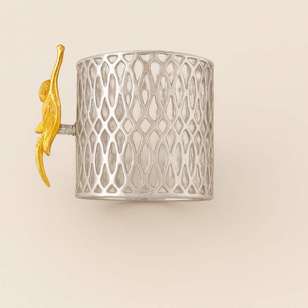 Blossom Napkin Rings - A set of napkin rings with silver and gold colors, featuring a floral design, displayed on a dining table from House of Pehr