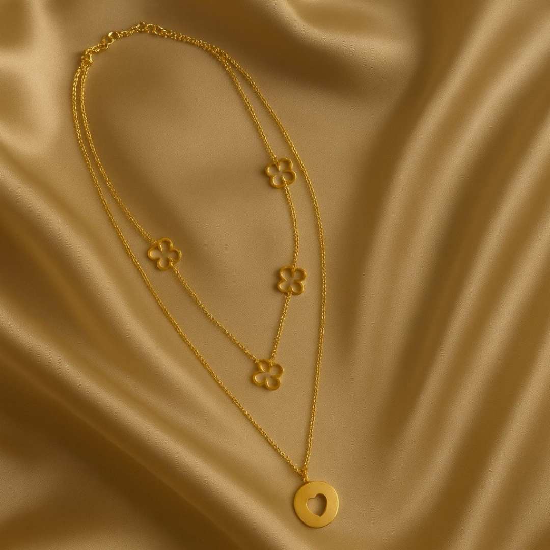 Amora Necklace from House of Pehr is a set of layered Gold plated necklaces with floral and heart motifs.