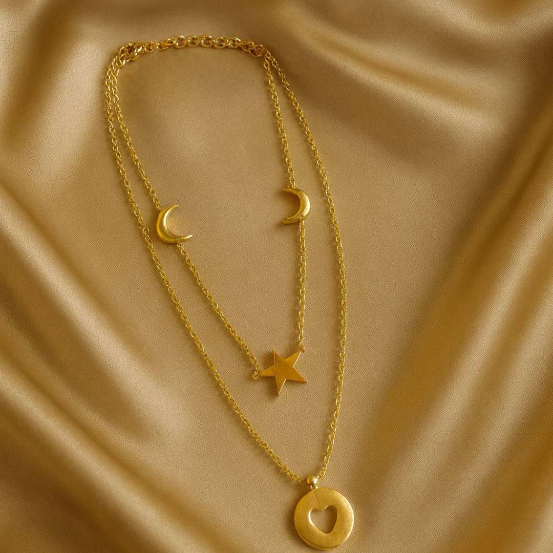 Celesta Necklace from House of Pehr is a layered set of Gold plated necklaces with moon, star, and heart Motifs