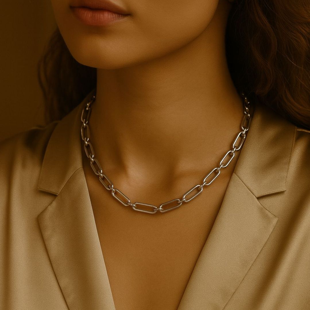Numa Chain Silver necklace worn by a person in a beige suit against a neutral background from House of Pehr
