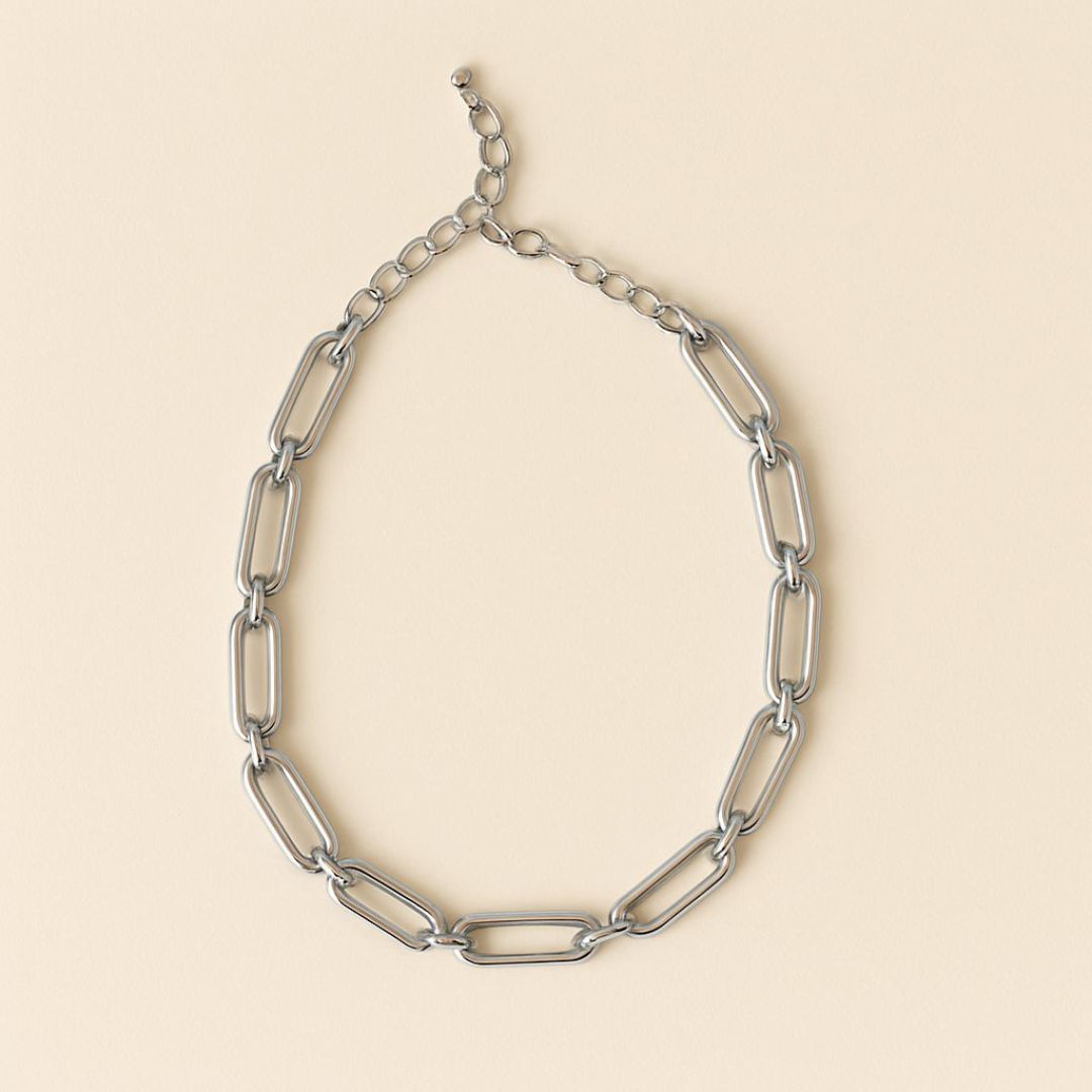 Numa Chain Silver necklace worn by a person in a beige suit against a neutral background from House of Pehr
