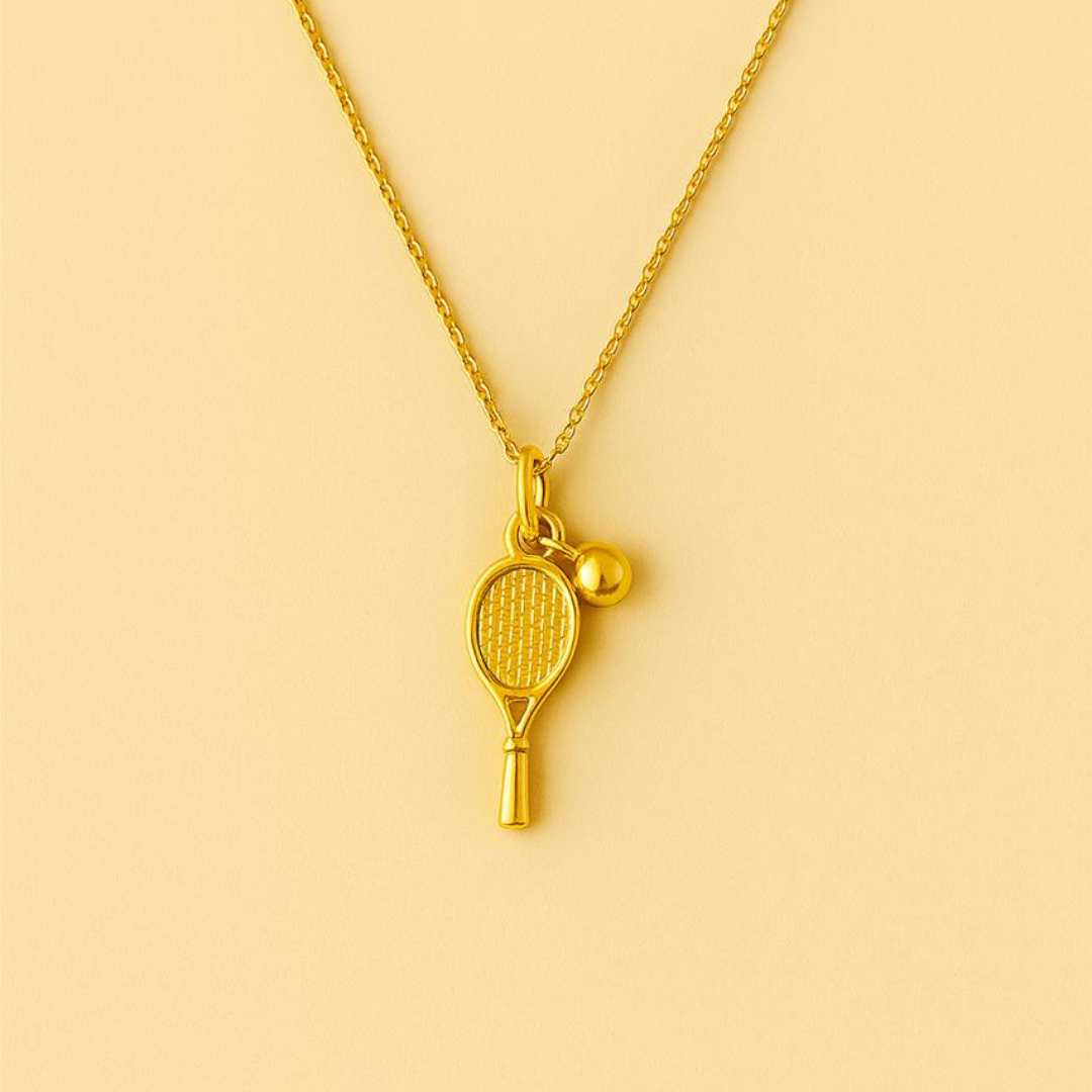 Gold necklace with tennis racket and ball pendant from House of Pehr