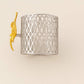 Blossom Napkin Rings - A set of napkin rings with silver and gold colors, featuring a floral design, displayed on a dining table from House of Pehr