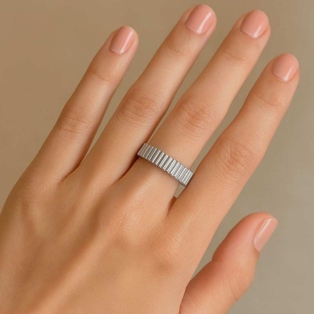 Hand wearing a silver Orbit ring on a beige background - Image 6