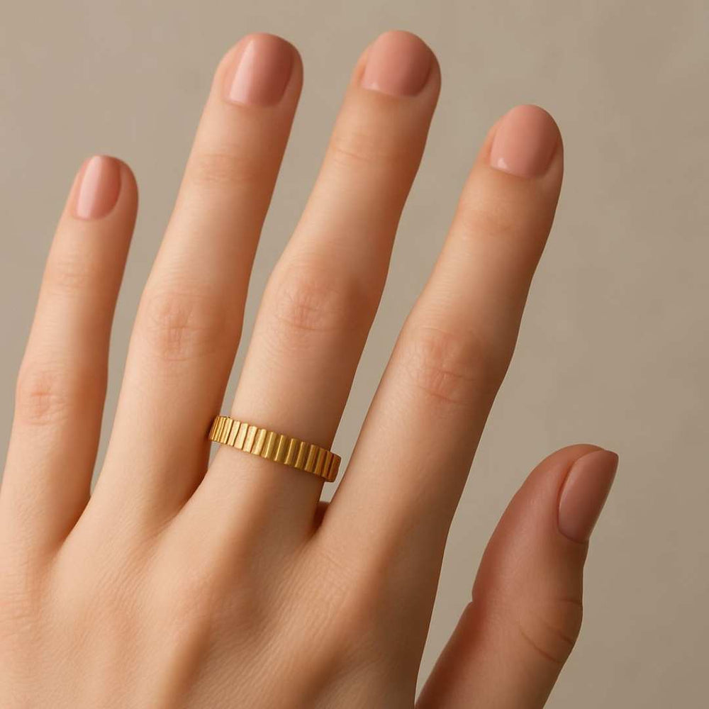 Hand wearing a Gold Orbit ring on a beige background - Image 4