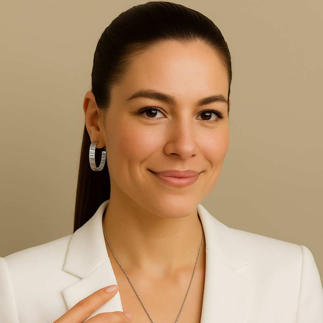 Woman wearing Silver Orbit hoop earrings with a neutral background from House of Pehr