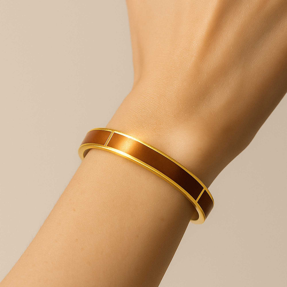 Dune Gold bangle on a wrist against a beige background - Image 3