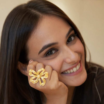 Woman wearing a gold ring flower design, from House Of Pehr