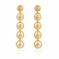 Gold earrings with circular design on a white background, solara earrings from house of pehr