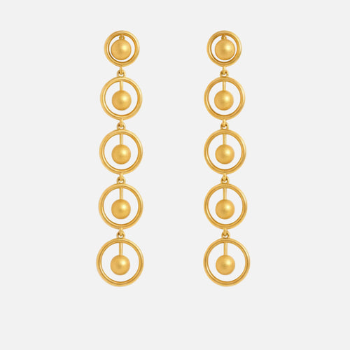 Gold earrings with circular design on a white background, solara earrings from house of pehr