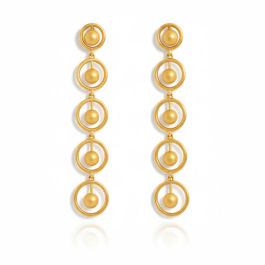 Gold earrings with circular design on a white background, solara earrings from house of pehr