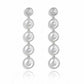 Silver earrings with multiple circular loops on a white background. solara earrings from house of pehr