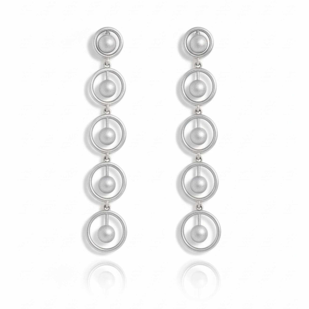 Silver earrings with multiple circular loops on a white background. solara earrings from house of pehr - Image 2