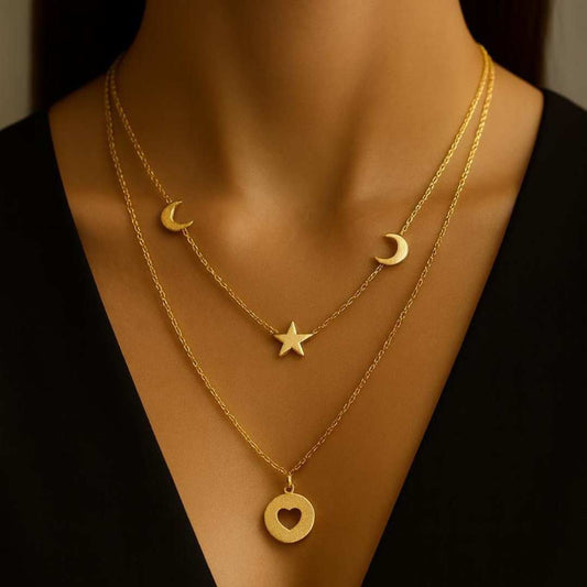 Celesta Necklace from House of Pehr is a layered set of Gold plated necklaces with moon, star, and heart Motifs.