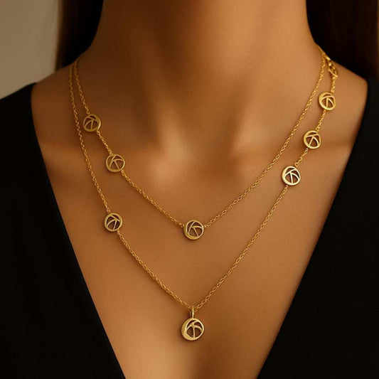 Orris Necklace from House of Pehr is a layered Gold plated necklace with peace symbol motifs 