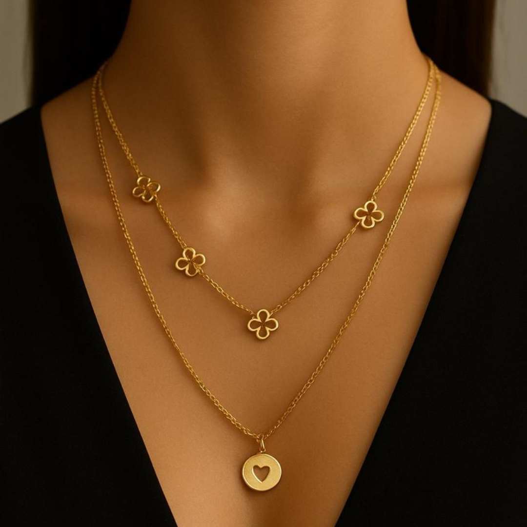 Amora Necklace from House of Pehr is a set of layered Gold plated necklaces with floral and heart motifs.
