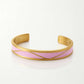 Gold bracelet with a pink band on a white background, Serena Bangles from House of Pehr