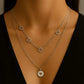 Amora Necklace from House of Pehr is a set of layered Silver plated necklaces with floral and heart motifs.