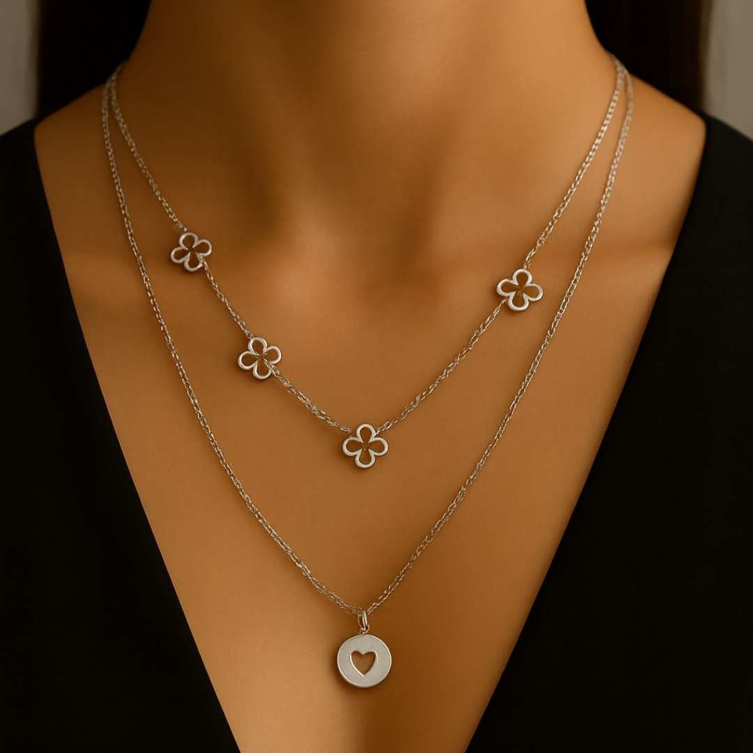 Amora Necklace from House of Pehr is a set of layered Silver plated necklaces with floral and heart motifs.