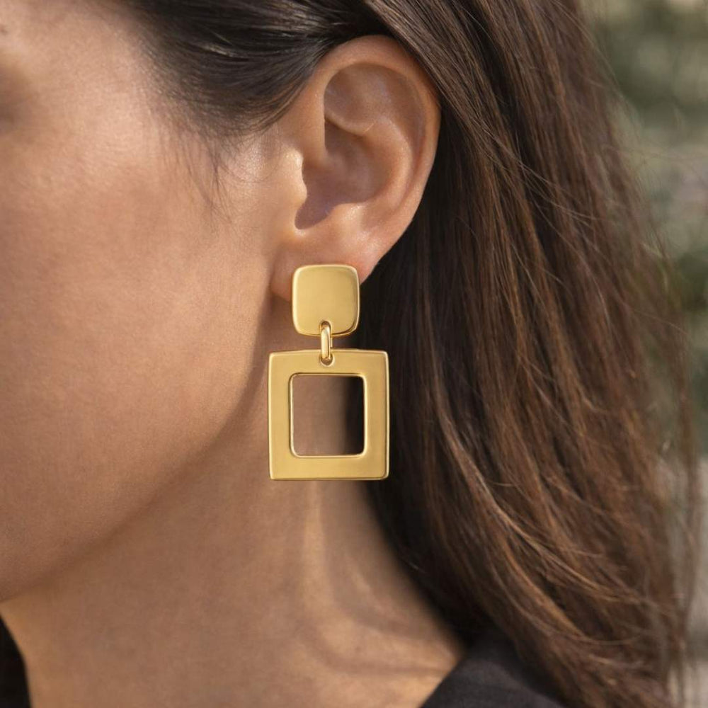 Gold square earrings worn by a person with blurred background from House of Pehr - Image 2