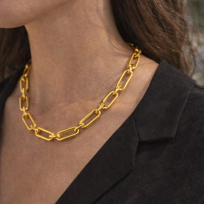 Gold chain necklace worn by a person from House of Pehr