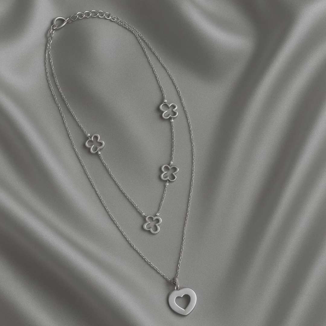 Amora Necklace from House of Pehr is a set of layered Silver plated necklaces with floral and heart motifs.