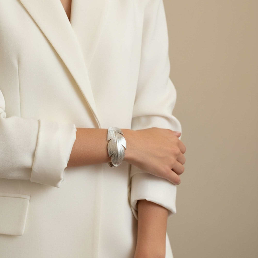 Person wearing a black blazer with a silver feather-shaped cuff, Zephyr Cuff from House of Pehr - Image 6