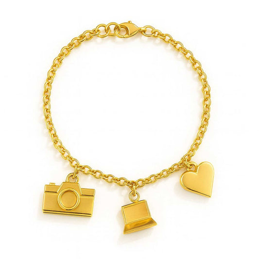 Gold bracelet with camera, laptop, and heart charms on a white background