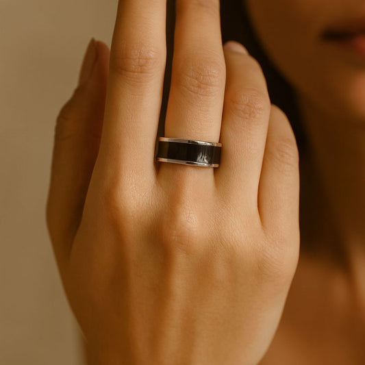 Close-up of a hand wearing a noire silver ring from House of Pehr