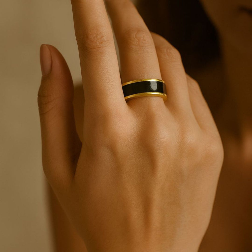 Close-up of a hand wearing a noire golden ring from House of Pehr - Image 7