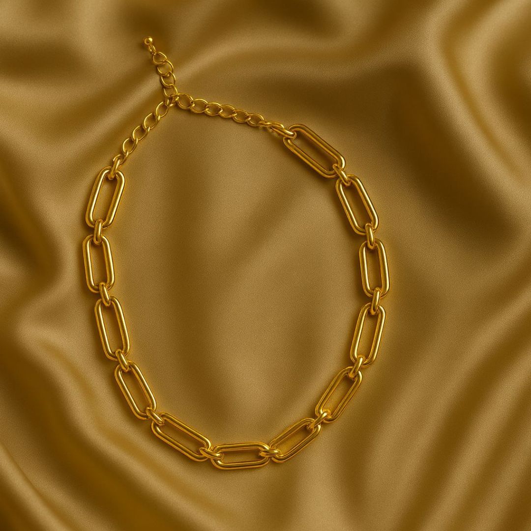 Numa Chain Gold necklace worn by a person in a beige suit against a neutral background from House of Pehr