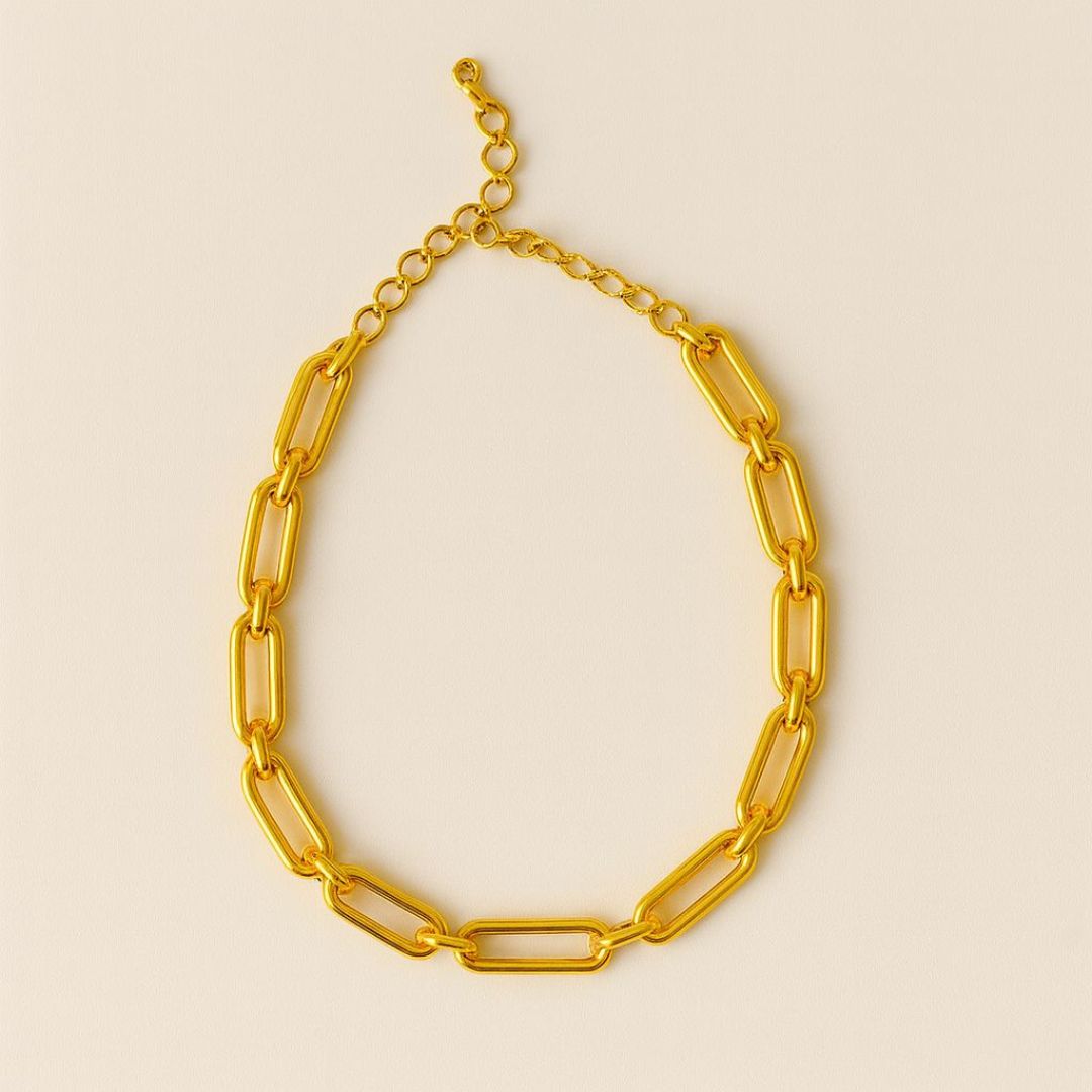Numa Chain Gold necklace worn by a person in a beige suit against a neutral background from House of Pehr