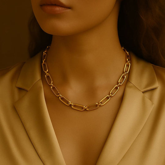 Numa Chain Gold necklace worn by a person in a beige suit against a neutral background from House of Pehr