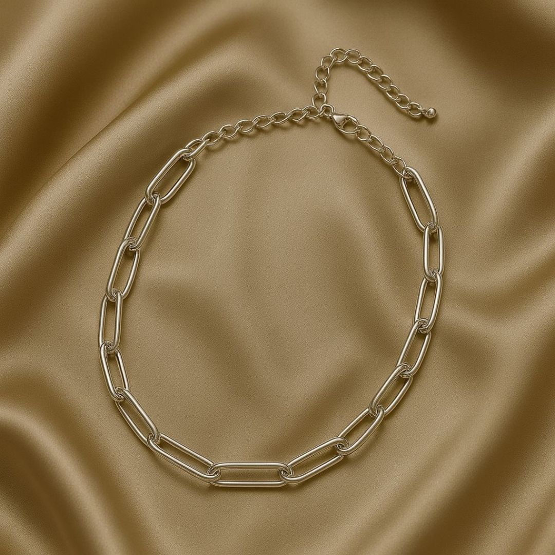 Numa Chain Silver necklace worn by a person in a beige suit against a neutral background from House of Pehr