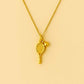 Gold necklace with tennis racket and ball pendant from House of Pehr