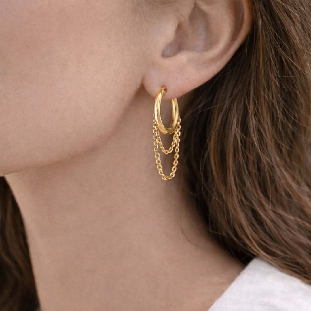 Gold hoop earrings with chain details worn by a person from House of Pehr 