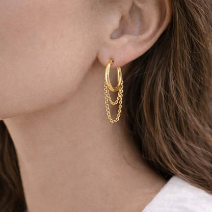 Gold hoop earrings with chain details worn by a person from House of Pehr 