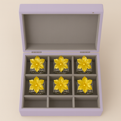 Blossom Napkin Rings - A set of napkin rings with silver and gold colors, featuring a floral design, displayed on a dining table from House of Pehr