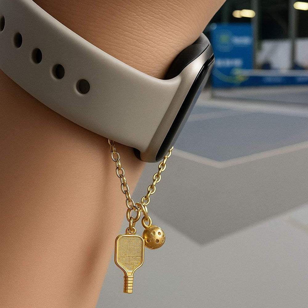 Gold watch charm with pickleball paddle and ball on a Watch against a blurred background - Image 5