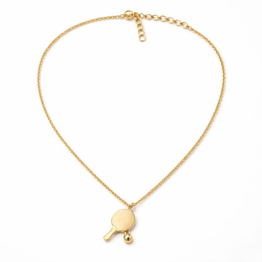 Gold necklace with a ping pong paddle pendant on a white background