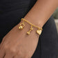 Gold bracelet with kettlebell, dumbbell, and heart charms on a wrist from House Of Pehr 