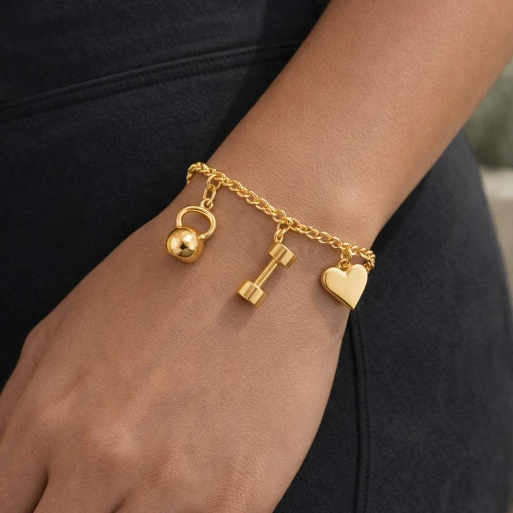 Gold bracelet with kettlebell, dumbbell, and heart charms on a wrist from House Of Pehr  - Image 3