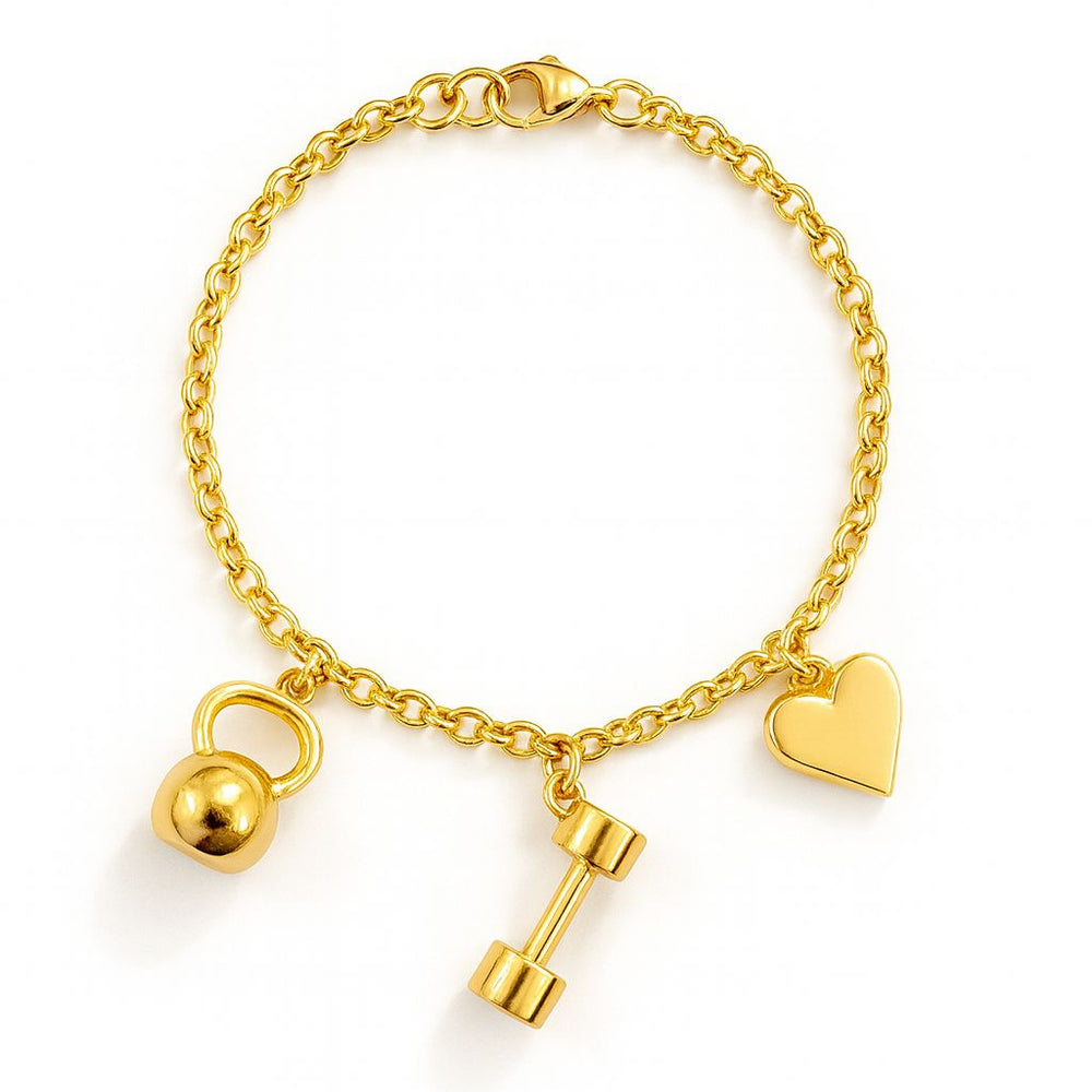 Gold bracelet with heart, dumbbell, and kettlebell charms on a white background. Invica bracelet from House of Pehr - Image 1